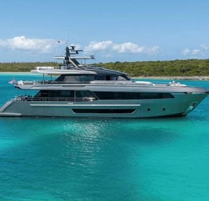 A Salt Weapon motor yacht anchored in crystal-clear turquoise waters.