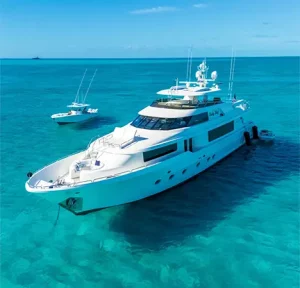 The Lucky Lady Motor Yacht anchored in the Bahamas with a tender nearby.