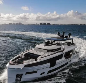 Aerial view of SAINT, an 88-foot luxury motor yacht cruising on open waters.